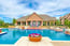 Spectacular Resort-Style Pool And Sundeck With In-Lay Loungers Cascading Fountains Poolside Cabanas And A Grilling Station 1 of 8